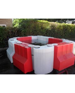 Modular Floodstop barrier system creating water containment area with red and white interlocking units
